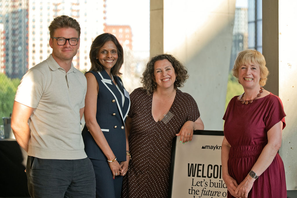 Maykn Co-Founder Laura Summers posing with speakers Hugh Viney, Seshni Jacobs and Rose Luckin by the event's welcome sign.